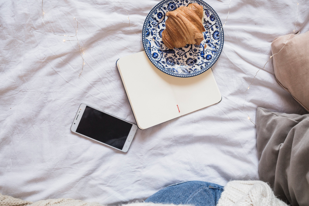 croissant-plate-near-notebook-smartphone